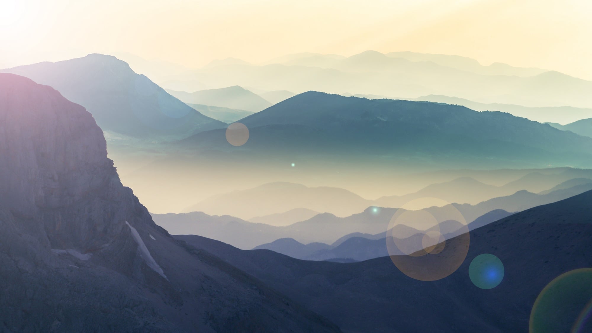 Layered mountain ridges in soft morning haze