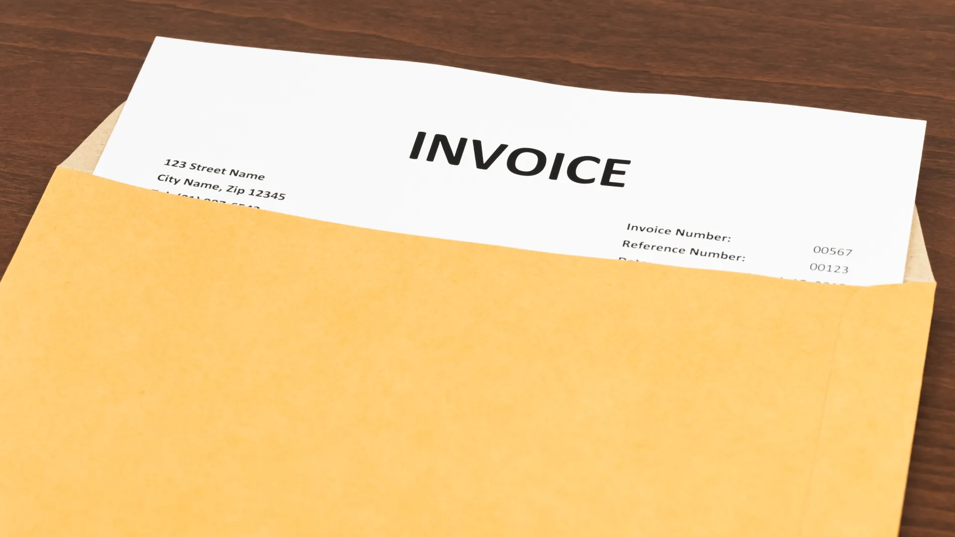 A printed invoice resting inside an envelope